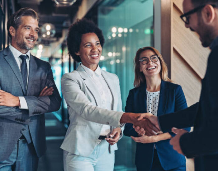 Group of business persons shaking hands in the office